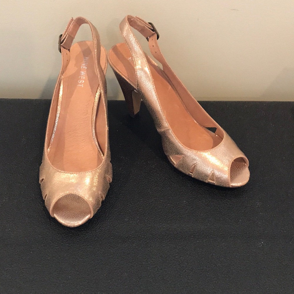 Gold open-toe high heels.